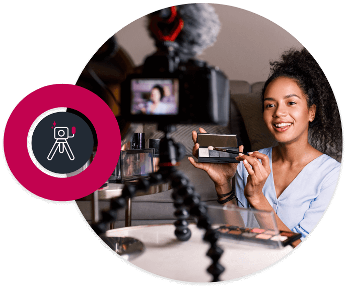 Picture in a circle of a young mixed race girl making a make up video with a camera on a tripod in front of her