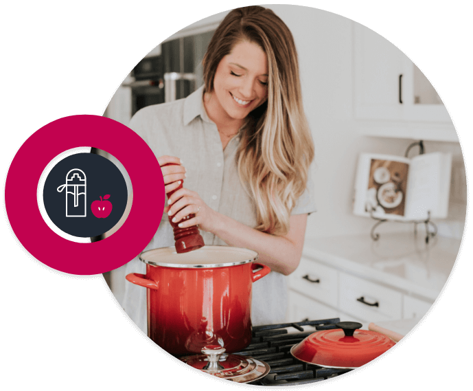 Picture in a circle of blond hair girl pouring pepper into caserole. In the background there is an open recipe book.